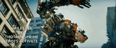 Robot Standing In Front Of Building Saying Hailes Lee Aka Thotamusprime Thots Activate GIF