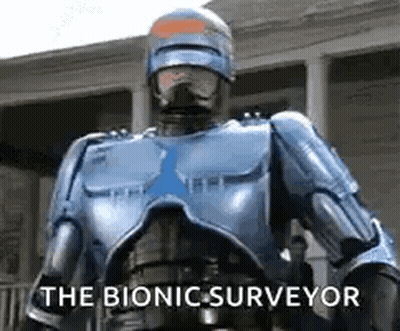 Robot Standing In Front Of Building Saying The Bionic Surveyor GIF
