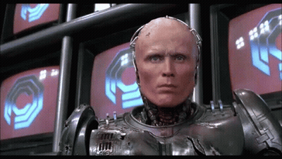Robot Standing In Front Of Monitors With O GIF