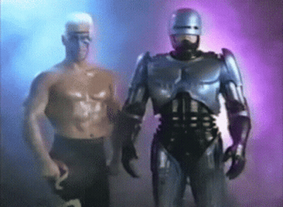 Robot Standing Next To Shirtless Man GIF