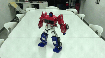 Robot Standing On Table In Room GIF