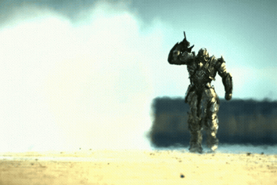 Robot Statue Standing In Sand GIF