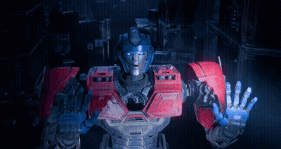 Robot With Blue And Red Arms Standing In Dark Room GIF