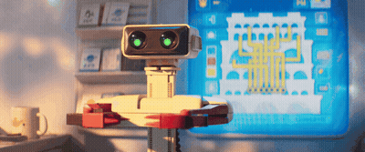 Robot With Green Eyes Sitting At Computer GIF