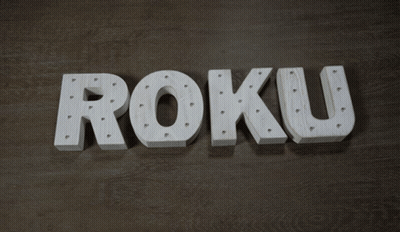 Roku White Letters On Wooden Surface GIF