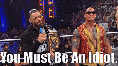Roman Reigns And The Rock Are Standing Next To Each Other In A Wrestling Ring With The Words You Must Be An Idiot Below  GIF