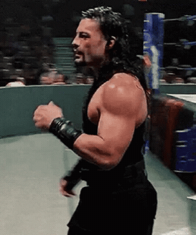 Roman Reigns Is A Wrestler With A Beard And Long Hair . GIF