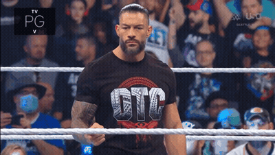 Roman Reigns Is Standing In A Wrestling Ring Wearing A Gfc Shirt GIF