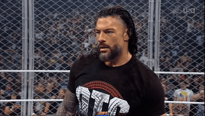 Roman Reigns Is Standing In A Wrestling Ring Wearing A T-Shirt That Says ' Tna ' . GIF