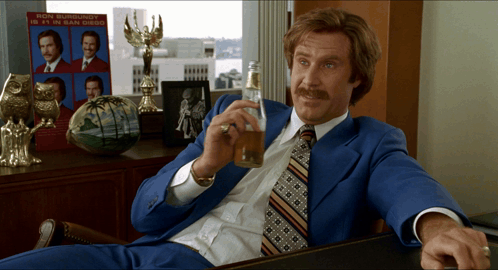Ron Burgundy Is 11 In San Diego On A Sign Behind Him GIF