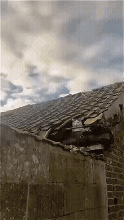 Roof With Hole And Cloudy Sky GIF