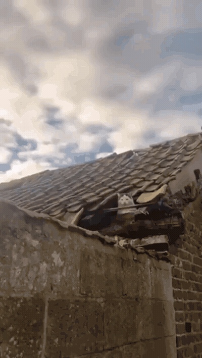 Roof With Hole And Cloudy Sky GIF