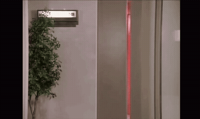Room With Plant And Elevator Sign GIF