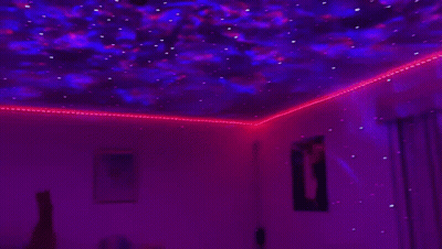Room With Projector Showing Starry Sky GIF