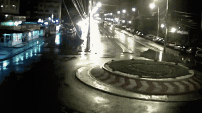 Roundabout At Night With Red And White Arrow GIF
