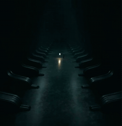 Row Of Chairs In Dark Room With Light GIF