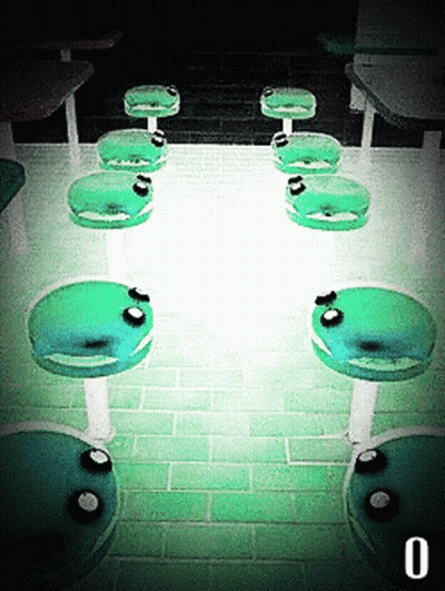 Row Of Green Chairs In Dark Room Number 0 GIF