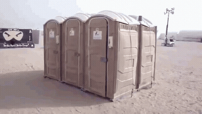 Row Of Portable Toilets With Strike Hard And Strike Clean Sign GIF