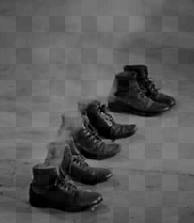 Row Of Shoes On Concrete Floor GIF