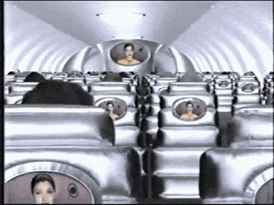 Row Of Silver Airplane Seats With Man In Back GIF