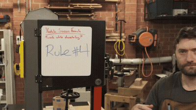 Rule # 4 Is Written On A White Board In Front Of A Band Saw GIF