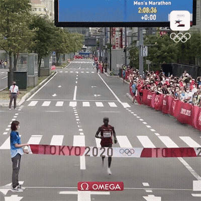 Runner Crosses Finish Line At Tokyo 2020 Marathon GIF