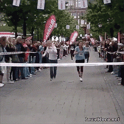 Runner Crossing Finish Line With Rescue Banner GIF