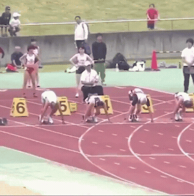 Runners Ready On Track With Numbered Blocks GIF