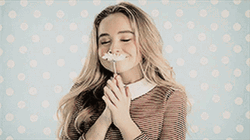 Sabrina Carpenter Holding A Flower GIF
