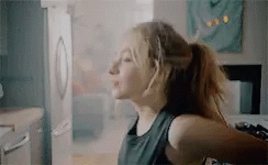 Sabrina Carpenter Sitting On Countertop GIF