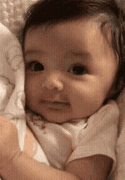 Sad Baby Lying On Blanket GIF