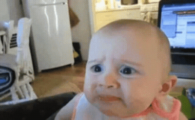 Sad Baby Sitting In Front Of Laptop GIF
