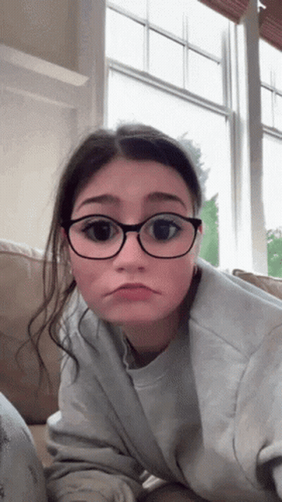 Sad Girl With Glasses Laying On Couch GIF