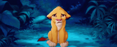 Sad Lion Cub Sitting In Jungle GIF