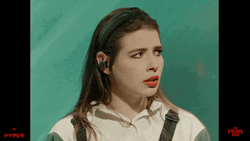 Sam Seum Ear Plugs While Wearing Headband GIF