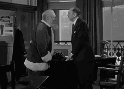 Santa Beats The Man Head GIF