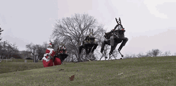 Santa Claus Robot Sleigh Reindeers GIF