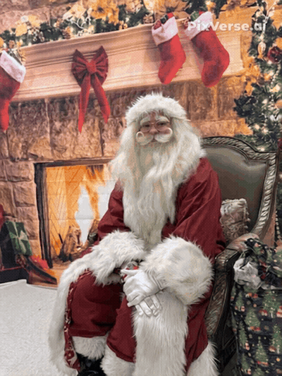 Santa Claus Sitting By Fireplace With Christmas Stockings GIF