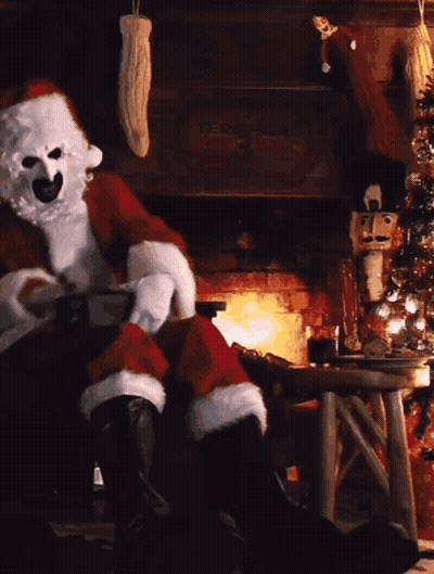 Santa Claus Sitting By Fireplace With Christmas Tree GIF