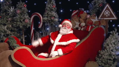 Santa Claus Sitting In Sleigh With Candy Canes And Teddy Bears GIF