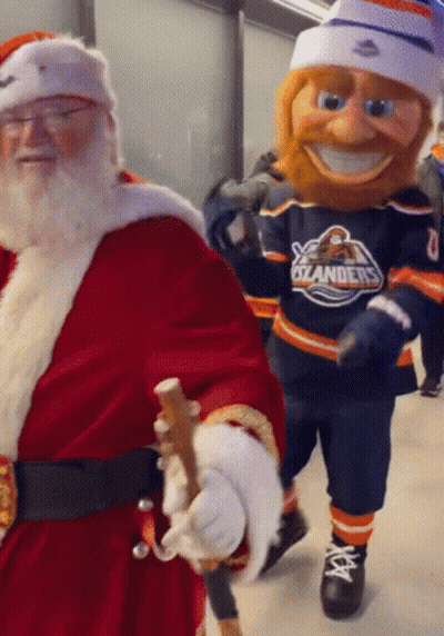 Santa Claus Walking Next To Oilers Mascot GIF