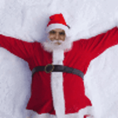 Santa Laying On Snow With Arms Outstretched GIF