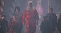 Santa Moving With His Assistants GIF
