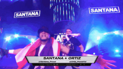 Santana And Ortiz On Stage In Dark Room GIF