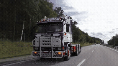 Scania Truck Driving Down Highway With Trees GIF