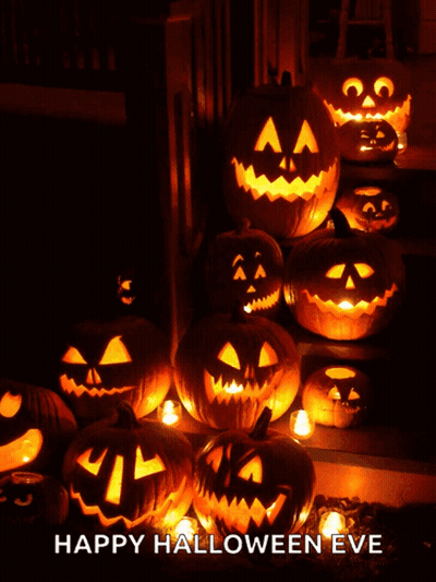 Scarecrow Next To Carved Pumpkin In Dark GIF