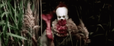 Scary Clown In Tall Grass Field GIF