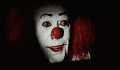 Scary Clown Red Eyes Facing Man In Suspenders GIF