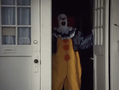 Scary Clown Standing In Dark Doorway GIF