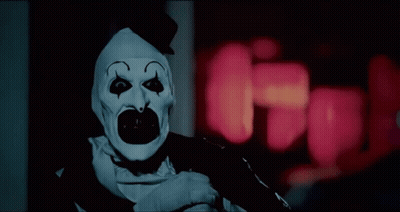 Scary Clown Standing In Dark Room GIF